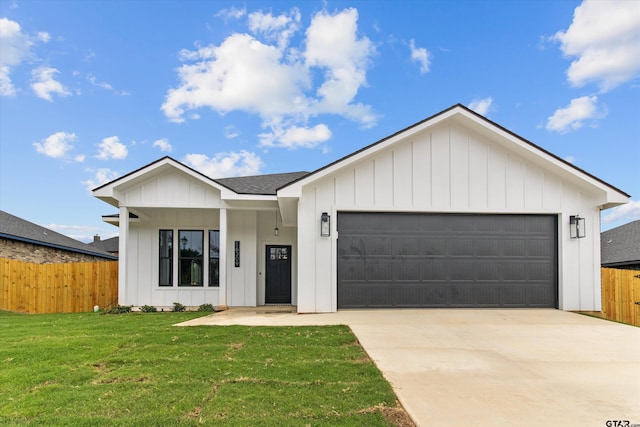 view of front of property with a front yard and a garage