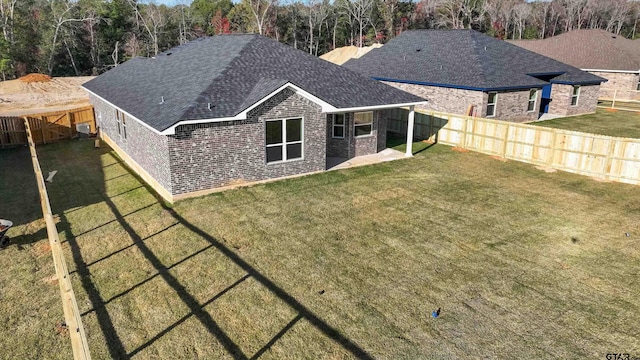 back of property featuring a patio and a yard