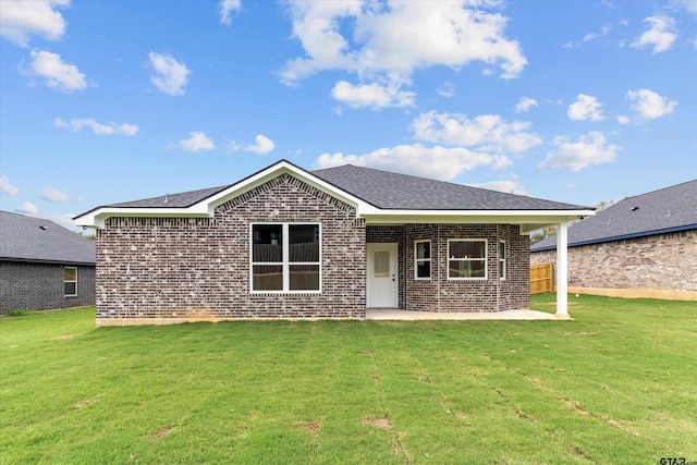 ranch-style house featuring a front yard and a patio area