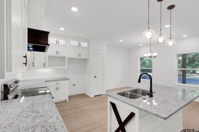 kitchen featuring stainless steel electric range oven, sink, light stone countertops, decorative light fixtures, and white cabinets