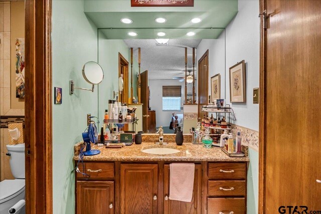5626 Meadowdale Rd, Flint, TX 75762 - bathroom with vanity, ceiling fan, and a textured ceiling