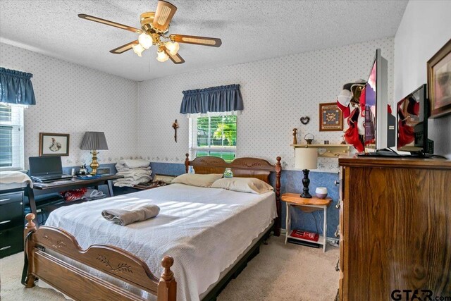 5626 Meadowdale Rd, Flint, TX 75762 - bedroom with carpet floors, wallpapered walls, a textured ceiling, and a ceiling fan