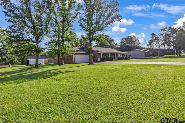 5626 Meadowdale Rd, Flint, TX 75762 - ranch-style house featuring a garage, a front yard, a chimney, and driveway