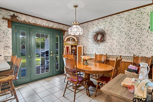 5626 Meadowdale Rd, Flint, TX 75762 - dining room featuring wallpapered walls, crown molding, a textured ceiling, light tile patterned flooring, and a chandelier