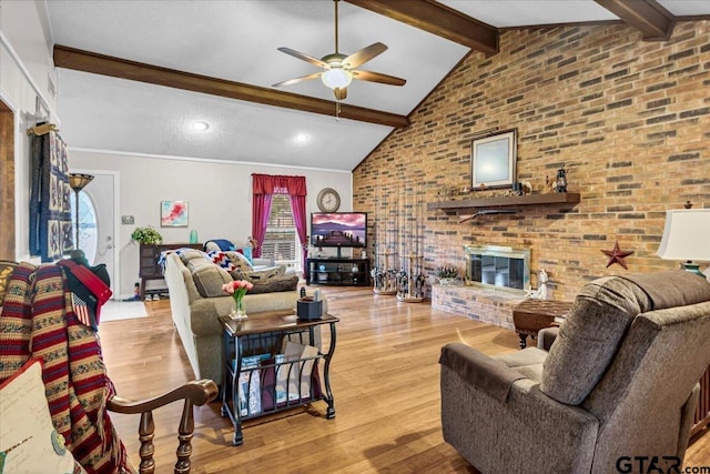 5626 Meadowdale Rd, Flint, TX 75762 - living room with a ceiling fan, beam ceiling, a brick fireplace, light wood finished floors, and brick wall