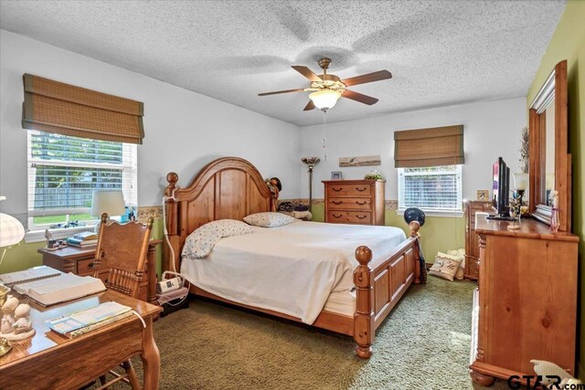 5626 Meadowdale Rd, Flint, TX 75762 - bedroom featuring multiple windows, light colored carpet, a textured ceiling, and a ceiling fan