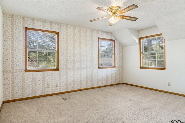 2222 County Road 1570, Alba, TX 75410 - bonus room featuring carpet, a textured ceiling, vaulted ceiling, a ceiling fan, and baseboards