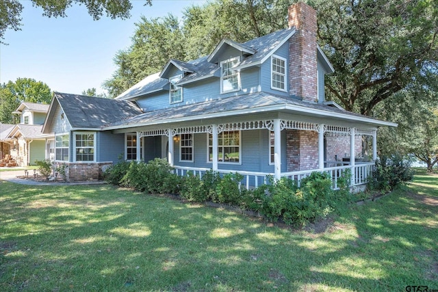 2222 County Road 1570, Alba, TX 75410 - view of front of house with a chimney, covered porch, a front yard, and brick siding
