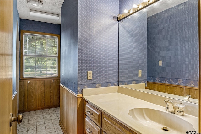 2222 County Road 1570, Alba, TX 75410 - bathroom featuring vanity, wood walls, wallpapered walls, a wainscoted wall, and a textured ceiling