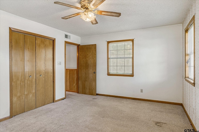 2222 County Road 1570, Alba, TX 75410 - unfurnished bedroom with carpet floors, a textured ceiling, a closet, ceiling fan, and baseboards