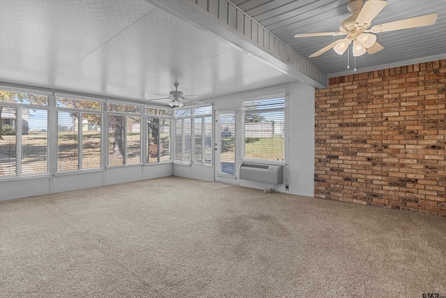 unfurnished sunroom featuring beamed ceiling, plenty of natural light, ceiling fan, and cooling unit