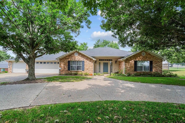 ranch-style home with a garage and a front lawn