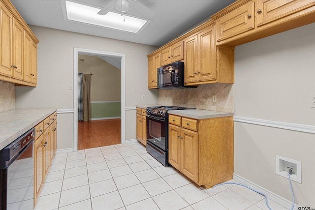 kitchen featuring black appliances, ceiling fan, light tile patterned floors, and backsplash