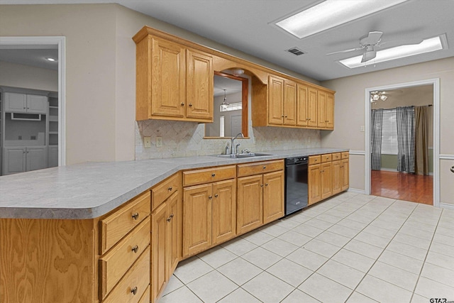 kitchen featuring backsplash, ceiling fan with notable chandelier, sink, light tile patterned floors, and dishwasher