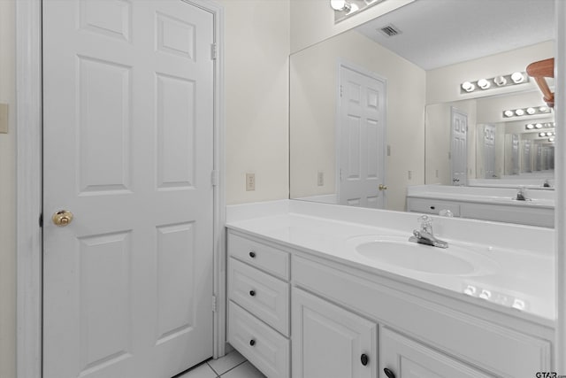 bathroom with tile patterned floors and vanity