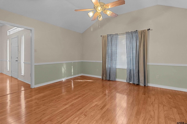 unfurnished room with ceiling fan, hardwood / wood-style floors, and lofted ceiling