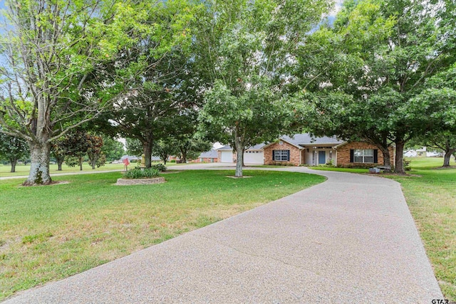 view of front of home featuring a garage and a front yard