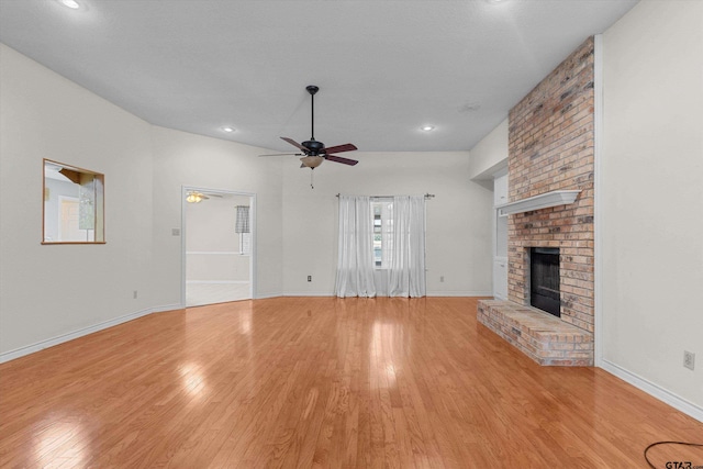 unfurnished living room featuring a fireplace, light hardwood / wood-style flooring, and ceiling fan