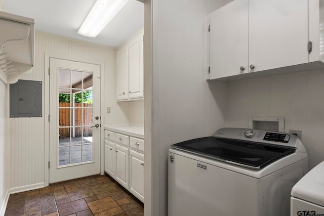 laundry area with electric panel, washer and clothes dryer, and cabinets