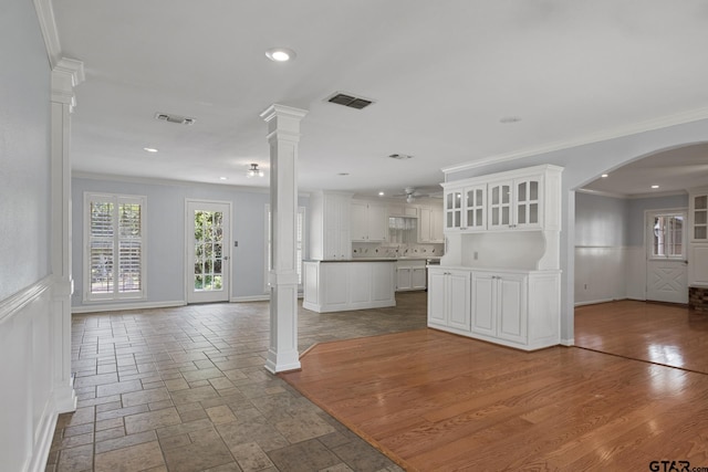 909 Elizabeth St, Gilmer, TX 75644 - unfurnished living room with ornamental molding, a decorative wall, arched walkways, recessed lighting, and wainscoting