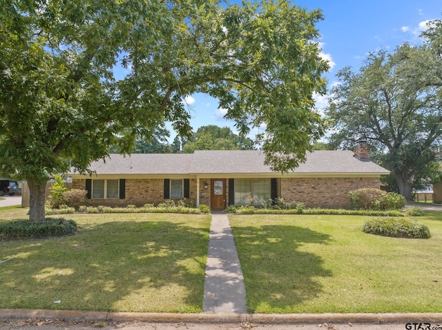 ranch-style home with a front lawn