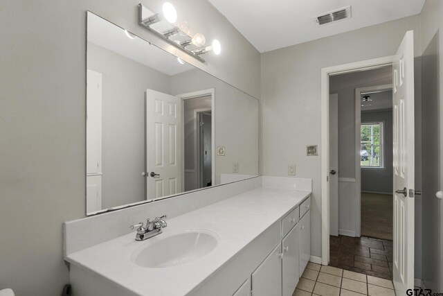 909 Elizabeth St, Gilmer, TX 75644 - bathroom featuring vanity and baseboards