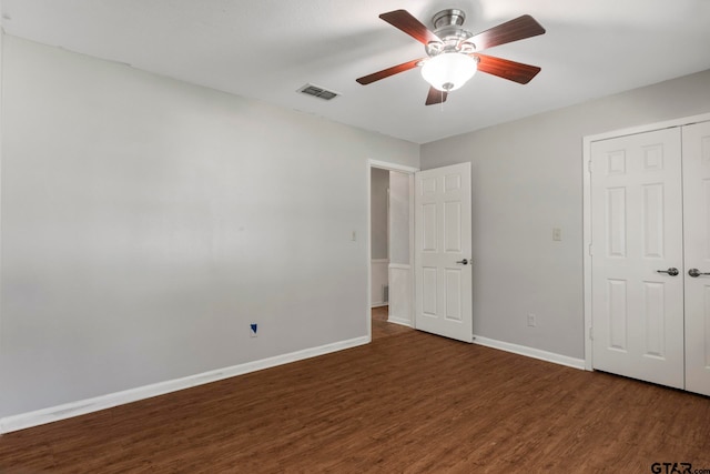 unfurnished bedroom featuring a closet, ceiling fan, and dark hardwood / wood-style floors