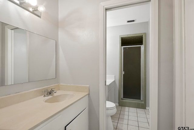 bathroom featuring toilet, vanity, an enclosed shower, and tile patterned flooring