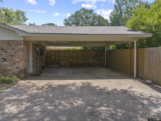 909 Elizabeth St, Gilmer, TX 75644 - view of vehicle parking with fence, a carport, and driveway