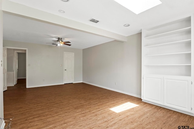 empty room featuring hardwood / wood-style flooring and ceiling fan