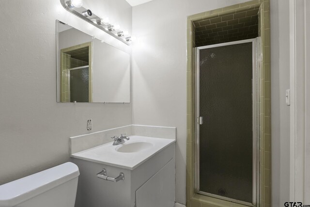 909 Elizabeth St, Gilmer, TX 75644 - full bathroom with a stall shower, toilet, and vanity