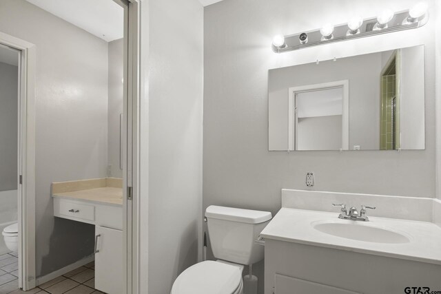 909 Elizabeth St, Gilmer, TX 75644 - bathroom featuring toilet, vanity, and tile patterned floors