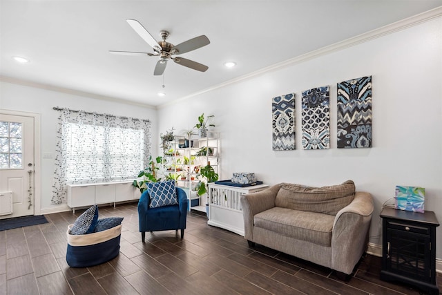 living area with crown molding and ceiling fan