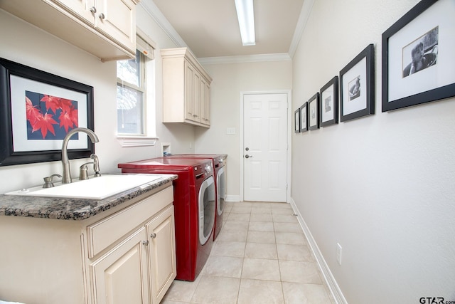 washroom featuring crown molding, light tile patterned floors, cabinet space, a sink, and washer and dryer