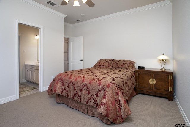 bedroom featuring crown molding, light colored carpet, visible vents, ensuite bathroom, and baseboards