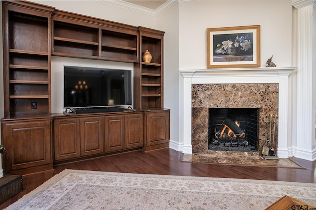 unfurnished living room with ornamental molding, a high end fireplace, and dark wood-style floors