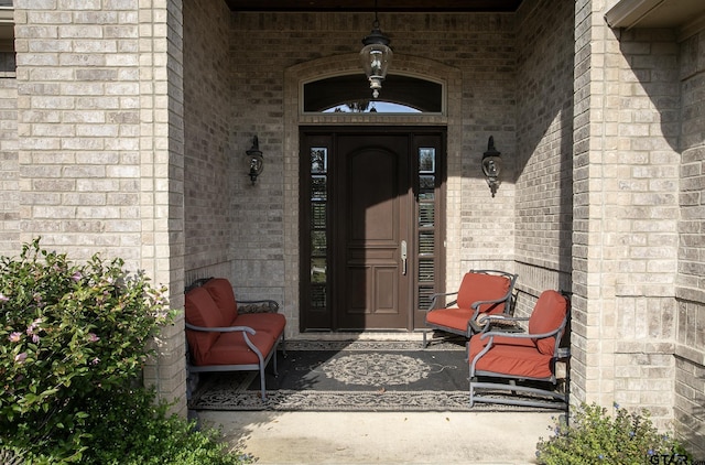 entrance to property featuring brick siding