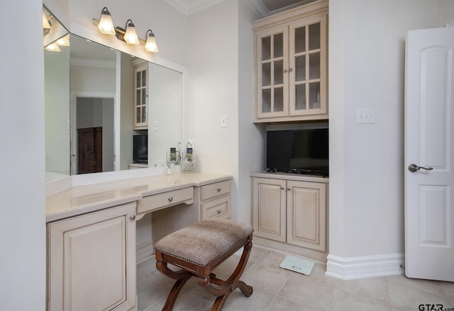 bathroom featuring tile patterned flooring, crown molding, vanity, and baseboards