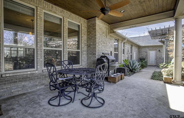 view of patio / terrace with grilling area, a ceiling fan, and outdoor dining space