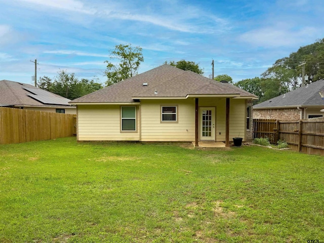 rear view of house with a yard