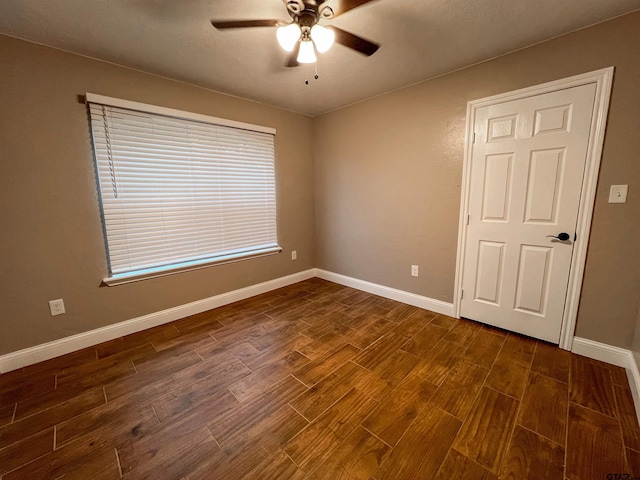 empty room featuring ceiling fan and dark wood-type flooring