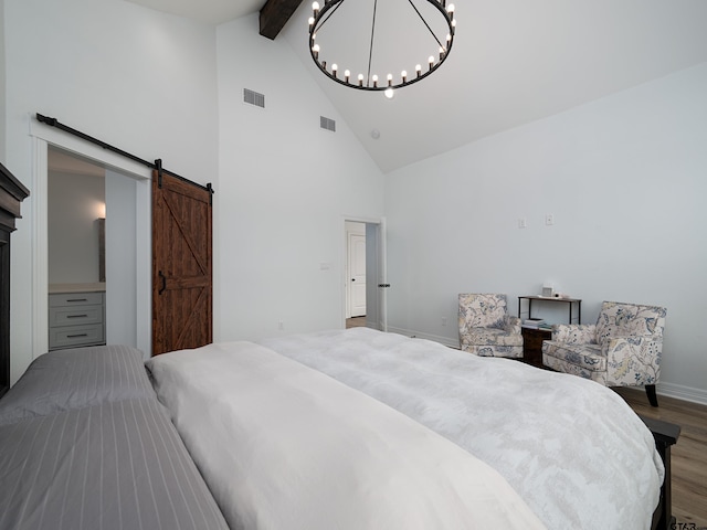 bedroom with a chandelier, visible vents, beam ceiling, and wood finished floors