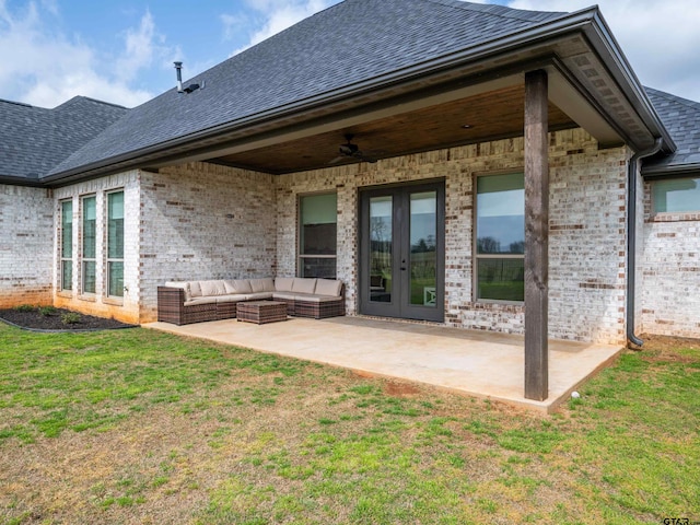 rear view of property featuring a patio, french doors, a yard, an outdoor hangout area, and brick siding