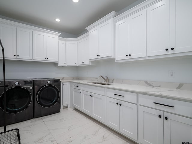 clothes washing area with washer and clothes dryer, recessed lighting, cabinet space, marble finish floor, and a sink