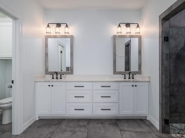 full bath featuring a shower stall, toilet, double vanity, and a sink