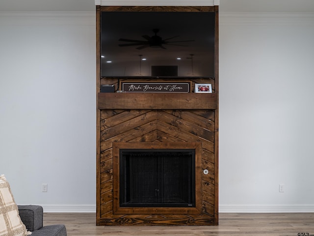 details featuring baseboards, wood finished floors, and crown molding