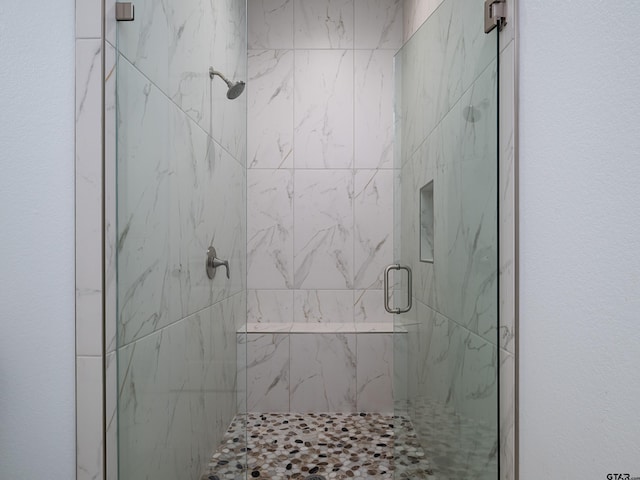 full bathroom with a marble finish shower