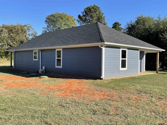 view of side of home with a yard