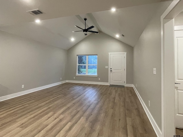 interior space with hardwood / wood-style flooring, ceiling fan, and lofted ceiling with beams