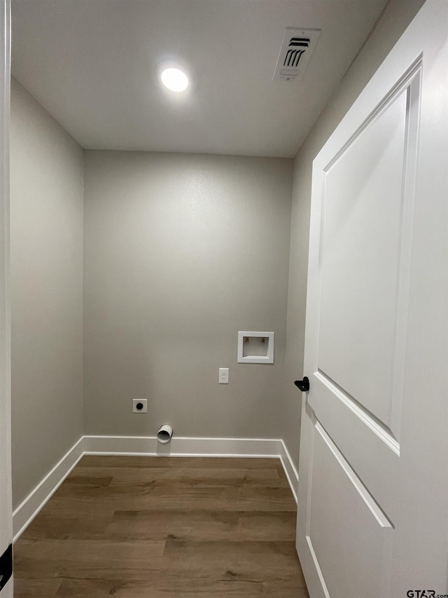 clothes washing area featuring hardwood / wood-style floors, hookup for an electric dryer, and hookup for a washing machine